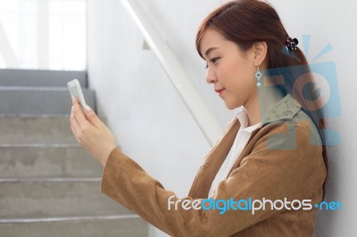 Portrait Of Thai Adult Businesswoman Beautiful Girl Using Her Smart Phone Stock Photo