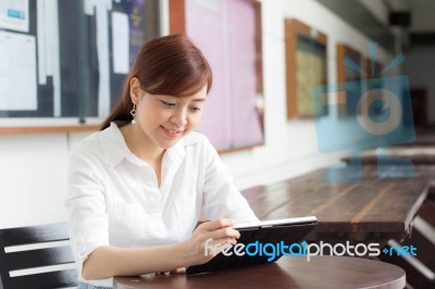 Portrait Of Thai Adult Businesswoman Beautiful Girl Using Her Tablet Stock Photo