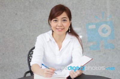 Portrait Of Thai Adult Businesswoman Beautiful Girl Write A Book… Stock Photo