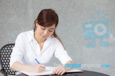 Portrait Of Thai Adult Businesswoman Beautiful Girl Write A Book… Stock Photo