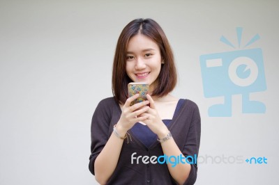 Portrait Of Thai Adult Student University Beautiful Girl Using Her Smart Phone Stock Photo