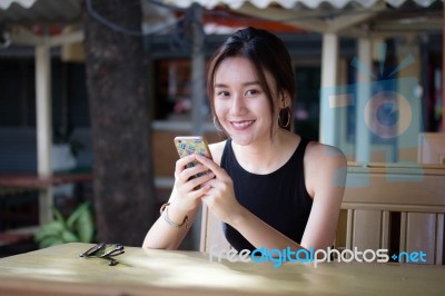 Portrait Of Thai Adult Student University Beautiful Girl Using Her Smart Phone Stock Photo