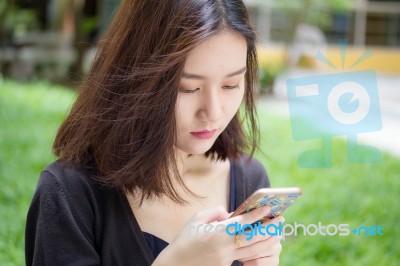 Portrait Of Thai Adult Student University Beautiful Girl Using Her Smart Phone Stock Photo