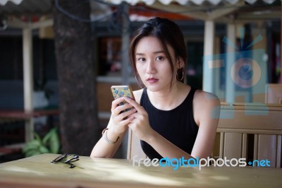 Portrait Of Thai Adult Student University Beautiful Girl Using Her Smart Phone Stock Photo