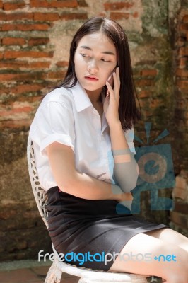 Portrait Of Thai Adult Student University Beautiful Girl Using Her Smart Phone Stock Photo