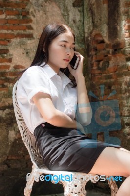 Portrait Of Thai Adult Student University Beautiful Girl Using Her Smart Phone Stock Photo