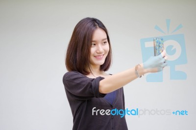 Portrait Of Thai Adult Student University Beautiful Girl Using Her Smart Phone Selfie Stock Photo