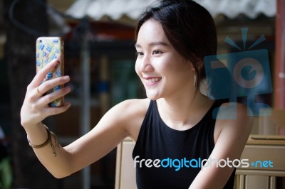 Portrait Of Thai Adult Student University Beautiful Girl Using Her Smart Phone Selfie Stock Photo