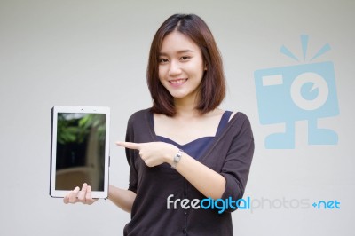 Portrait Of Thai Adult Student University Beautiful Girl Using Her Tablet Stock Photo