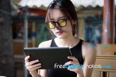 Portrait Of Thai Adult Student University Beautiful Girl Using Her Tablet Stock Photo