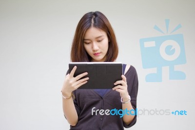 Portrait Of Thai Adult Student University Beautiful Girl Using Her Tablet Stock Photo