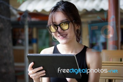 Portrait Of Thai Adult Student University Beautiful Girl Using Her Tablet Stock Photo