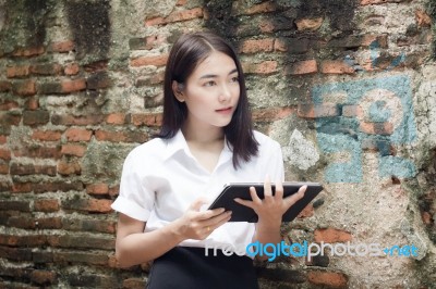 Portrait Of Thai Adult Student University Beautiful Girl Using Her Tablet Stock Photo