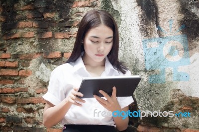 Portrait Of Thai Adult Student University Beautiful Girl Using Her Tablet Stock Photo