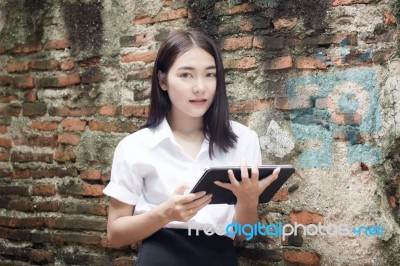 Portrait Of Thai Adult Student University Beautiful Girl Using Her Tablet Stock Photo