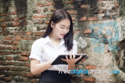 Portrait Of Thai Adult Student University Beautiful Girl Using Her Tablet Stock Photo