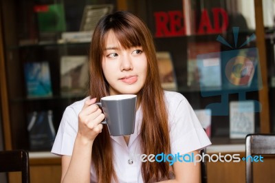 Portrait Of Thai Adult Student University Uniform Beautiful Drinking Coffee Stock Photo