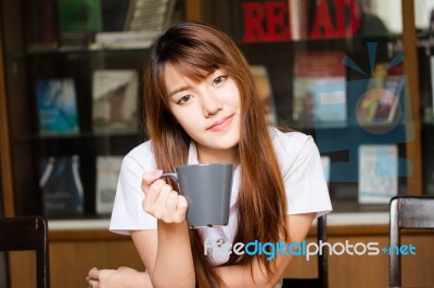 Portrait Of Thai Adult Student University Uniform Beautiful Drinking Coffee Stock Photo