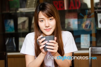 Portrait Of Thai Adult Student University Uniform Beautiful Drinking Coffee Stock Photo