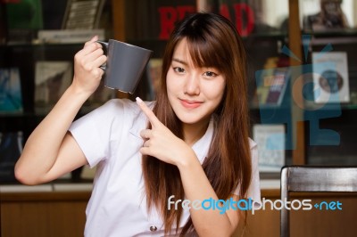 Portrait Of Thai Adult Student University Uniform Beautiful Drinking Coffee Stock Photo