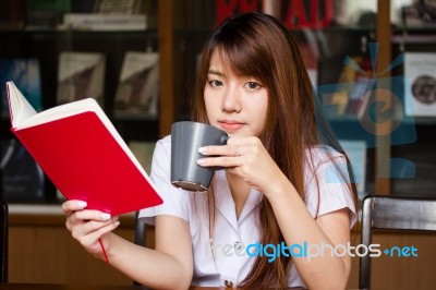 Portrait Of Thai Adult Student University Uniform Beautiful Drinking Coffee Stock Photo