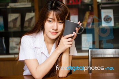 Portrait Of Thai Adult Student University Uniform Beautiful Drinking Coffee Stock Photo