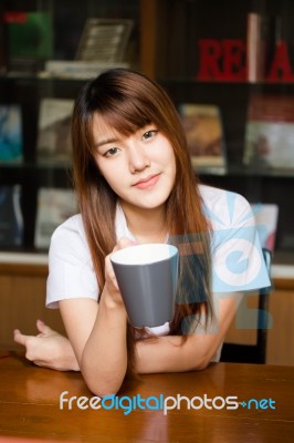 Portrait Of Thai Adult Student University Uniform Beautiful Drinking Coffee Stock Photo