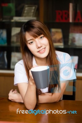 Portrait Of Thai Adult Student University Uniform Beautiful Drinking Coffee Stock Photo