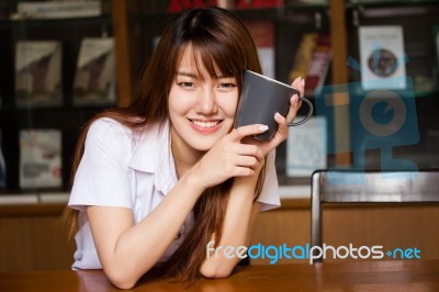 Portrait Of Thai Adult Student University Uniform Beautiful Drinking Coffee Stock Photo