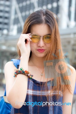 Portrait Of Thai Chinese Adult Glasses Beautiful Girl Denim Blue Bag Relax And Smile Stock Photo