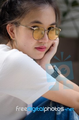 Portrait Of Thai Chinese Adult Glasses Beautiful Girl Denim Blue Bag Relax And Smile Stock Photo