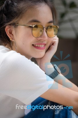 Portrait Of Thai Chinese Adult Glasses Beautiful Girl Denim Blue Bag Relax And Smile Stock Photo