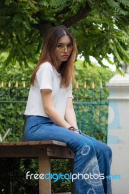 Portrait Of Thai Chinese Adult Glasses Beautiful Girl Denim Blue Bag Relax And Smile Stock Photo