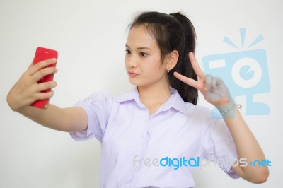 Portrait Of Thai High School Student Uniform Beautiful Girl Using Her Smart Phone Selfie Stock Photo