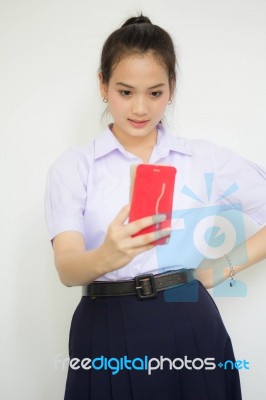 Portrait Of Thai High School Student Uniform Beautiful Girl Using Her Smart Phone Selfie Stock Photo