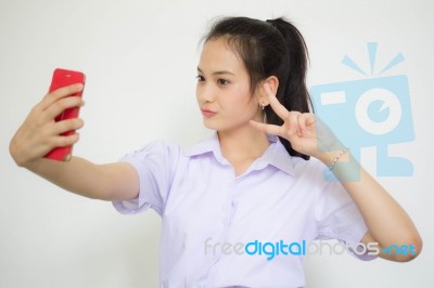 Portrait Of Thai High School Student Uniform Beautiful Girl Using Her Smart Phone Selfie Stock Photo