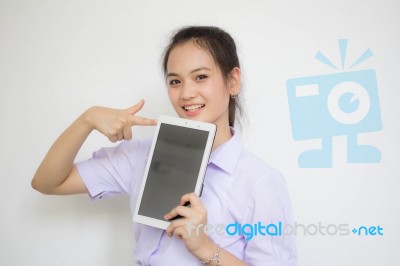 Portrait Of Thai High School Student Uniform Beautiful Girl Using Her Tablet Stock Photo