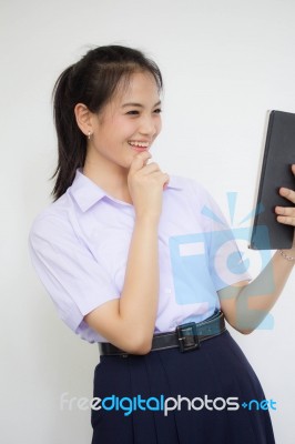 Portrait Of Thai High School Student Uniform Beautiful Girl Using Her Tablet Stock Photo