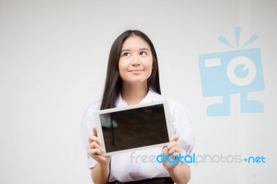 Portrait Of Thai High School Student Uniform Beautiful Girl Using Her Tablet Stock Photo