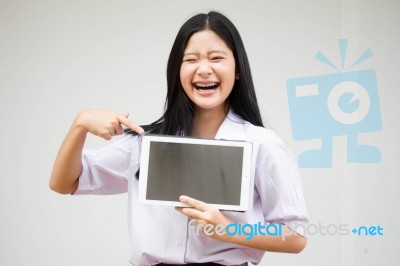 Portrait Of Thai High School Student Uniform Beautiful Girl Using Her Tablet Stock Photo