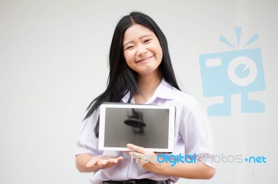 Portrait Of Thai High School Student Uniform Beautiful Girl Using Her Tablet Stock Photo