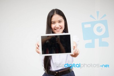 Portrait Of Thai High School Student Uniform Beautiful Girl Using Her Tablet Stock Photo