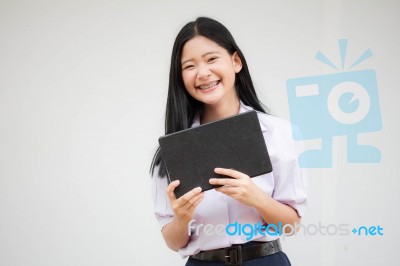 Portrait Of Thai High School Student Uniform Beautiful Girl Using Her Tablet Stock Photo