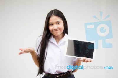 Portrait Of Thai High School Student Uniform Beautiful Girl Using Her Tablet Stock Photo