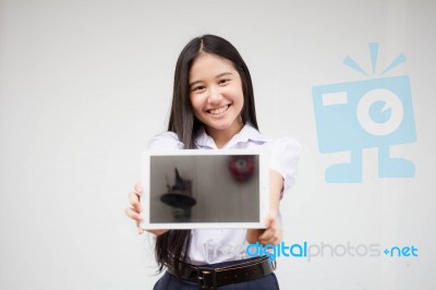 Portrait Of Thai High School Student Uniform Beautiful Girl Using Her Tablet Stock Photo