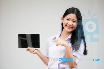 Portrait Of Thai High School Student Uniform Beautiful Girl Using Her Tablet Stock Photo