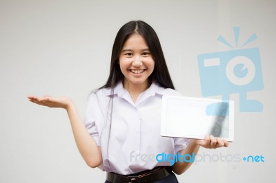 Portrait Of Thai High School Student Uniform Beautiful Girl Using Her Tablet Stock Photo