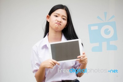 Portrait Of Thai High School Student Uniform Beautiful Girl Using Her Tablet Stock Photo