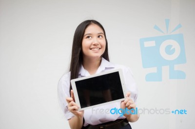 Portrait Of Thai High School Student Uniform Beautiful Girl Using Her Tablet Stock Photo