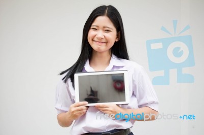 Portrait Of Thai High School Student Uniform Beautiful Girl Using Her Tablet Stock Photo